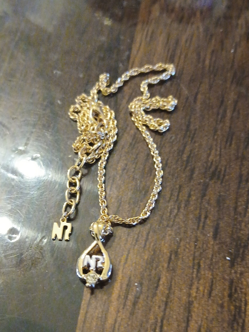 Nina Ricci gold-plated necklace features a teardrop pendant accented with Stone